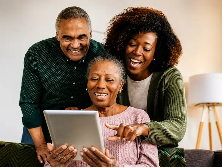 A smiling family gathered around their mother at home